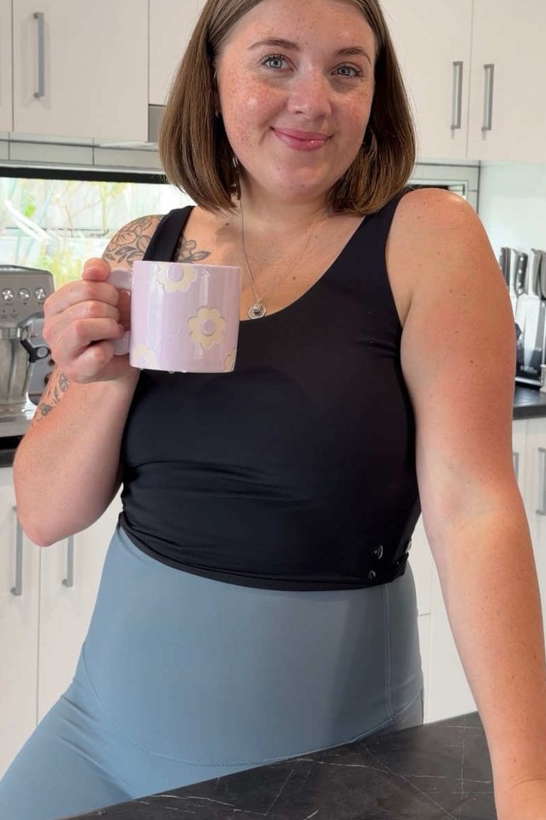 Woman holding a mug in a kitchen